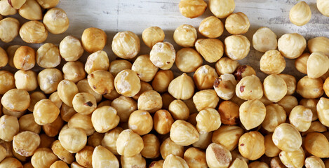 unshelled dry hazelnuts on wooden background