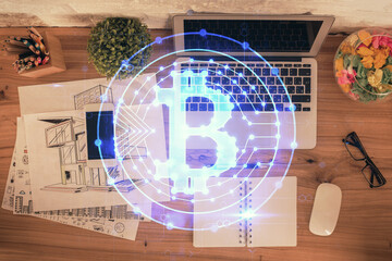 Blockchain theme hologram drawings over computer on the desktop background. Top view. Double exposure.