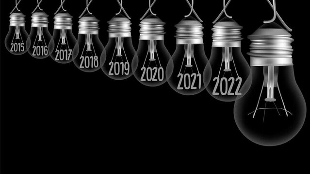 Shining light bulb with New Year 2023 and group of dark light bulbs in a row going from 2015 to 2022 isolated on black background. High quality 4k video.