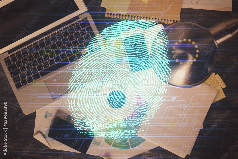 Poster Finger print over computer on the desktop background. Top view. Double exposure. Concept of securitization.