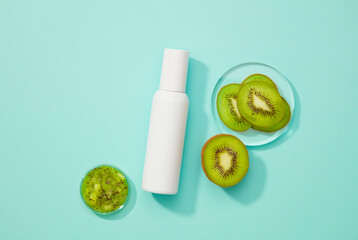 Empty cosmetic bottles next to a glass platform holding kiwi slices and a glass tray holding a fresh kiwi mask