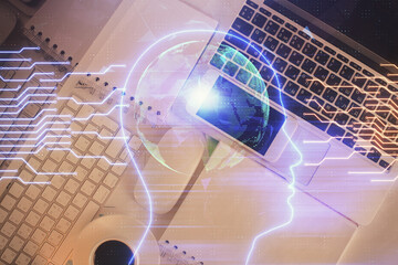 Double exposure of brain drawing hologram over topview work table background with computer. Concept of big data.