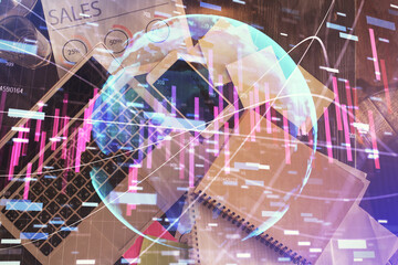 Financial market graph and top view computer on the desktop background. Multi exposure. Investment concept.