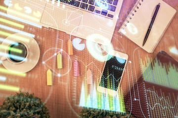 Double exposure of technology theme drawing over work table desktop. Top view. Global data analysis concept.