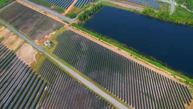 4K : Aerial view of a large solar panel during sunrise, clean sustainable energy, renewable electricity. environmental protection concept. drone
