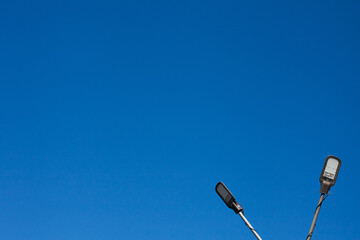 A modern street LED lighting pole for sity with blue sky. Urban electro-energy technologies....