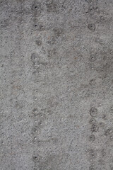 Dirty rough surface texture of sand screed cement, old gray concrete wall for background with uneven stains and tiny holes.