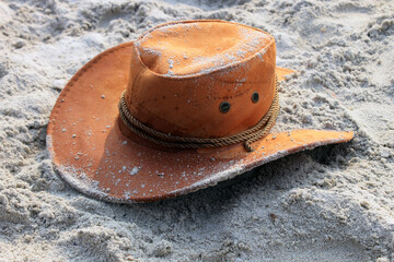 Cowboy round hat on the beach sand