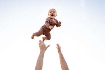 Baby laughing while being thrown in the air