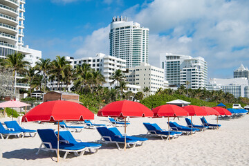 miami beach with sunloungers and umbrellas for summer vacation