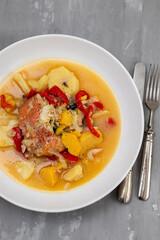 typical portuguese fish stew on white plate on ceramic