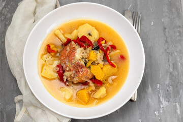 typical portuguese fish stew on white plate on ceramic