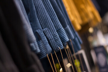 Close up on textile pattern background selection for men trousers, no people are visible.