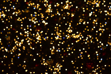 Gold and blue bokeh circles on a black background. Christmas colorful lights. Overlay