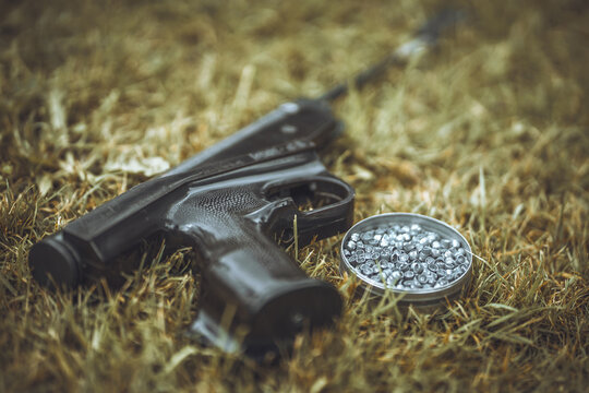 Pneumatic pistol and lead bullets for shooting. Air gun shooting training. Weapons without a license.