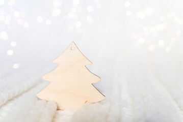 Wooden Christmas tree for your text on a white knitted background