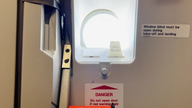 Airbus aircraft handle door and warning signs. Indoor close up view