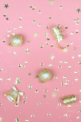 Pink background with glitter, golden stars and decorations. Sparkling texture. Festive backdrop for your projects