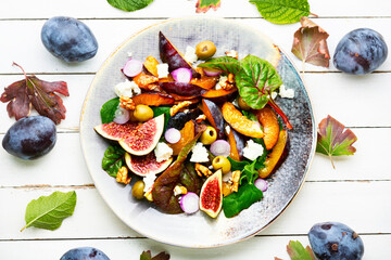 Vitamin salad with fruit, olives and herbs