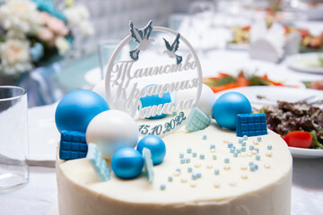white cake with blue decor, the inscription on the cake 
