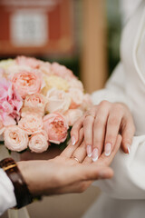 Well-groomed hands with beautiful nails on a background of flowers