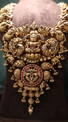 Bangalore, India 4th May 2022: Indian customer in a jewellery exhibition buying gold on the occasion of Dhanteras and Vijayalaxmi. Traditional ornaments with marvelous stones and intricate designs.