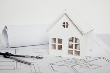 White house and engineer tools on blueprint house plan design close-up. Building concept