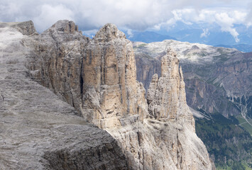 Fototapeta na wymiar The landscape of the Dolomites seen from the Sella group: one of the most famous and spectacular mountain massifs in the Alps, near the town of Canazei, Italy - July 2022.