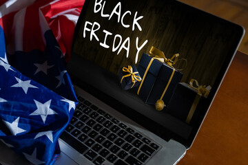 black friday on laptop next to american flag