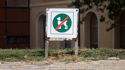 Dogs are not allowed sign. Green sign that prohibits walking with dogs in a park in Barcelona....