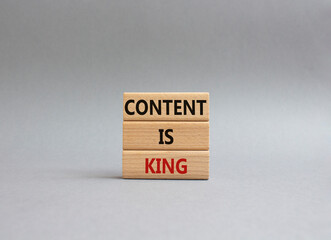 Content is king symbol. Concept words Content is king on wooden blocks. Beautiful grey background. Business and Content is king concept. Copy space.