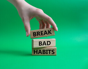 Break bad habits symbol. Concept words Break bad habits on wooden blocks. Beautiful green background. Doctor hand. Medicine and Break bad habits concept. Copy space.