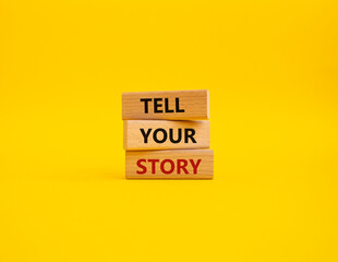 Tell your story symbol. Wooden blocks with words Tell your story. Beautiful yellow background. Business and Tell your story concept. Copy space.