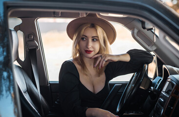 Obraz na płótnie Canvas Gorgeous blonde woman in a car, luxury style, concept lady and automobile vibe