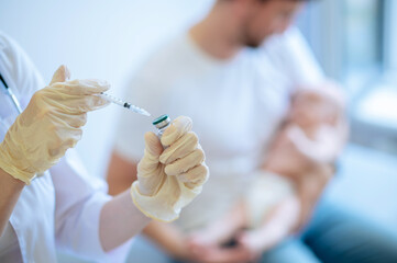 Physician preparing to give an injection to a patient