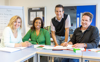 Adult Education: Mature Students. A teacher and his mature learners in class. From a series of...