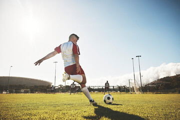 Football, training and kick with man on field playing for sports, fitness and goals strike. Exercise, workout and soccer ball with athlete on grass for health, wellness and competition games - Powered by Adobe