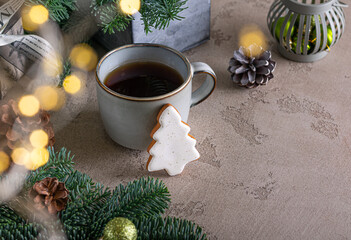 Gingerbread cookies with cup of tea on shiny background. Christmas tree shaped spicy biscuits....