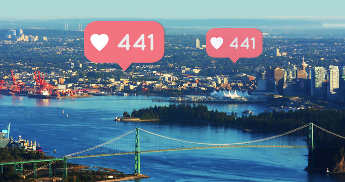 Composite of heart shapes and 441 number in speech bubbles over aerial view of cityscape - Powered by Adobe