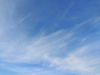 Blue sky with streaks of clouds