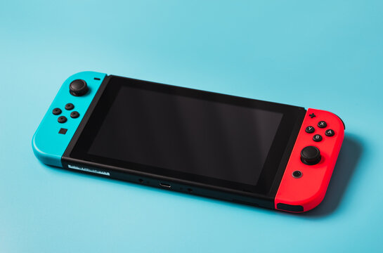 Milan, Italy-Oct. 2022: Nintendo Switch Game Console isolated copy space blue background.