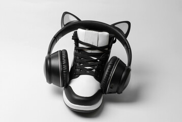 Fototapeta na wymiar Sneakers with wireless headphones on a white background