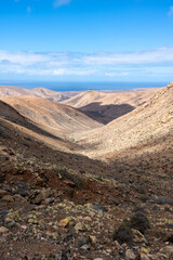 Spectacular landscape and desert of the volcanic island of Fuerteventura with the ocean in the background, Canary Islands