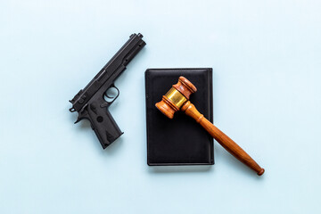 Gun law concept. Hand gun weapon and judges gavel. Crime background