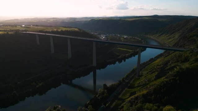 Moselle Viaduct, Winningen, Germany - romantic aerial drone flight Moseltalbr&uuml;cke and highway A61 over moselle valley, bridge connecting the Eifel mountains - bird view with water reflections
