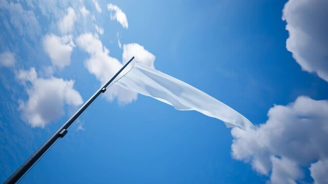 A bright white flag waving on the wind with blue cloudy sky in the background 4K