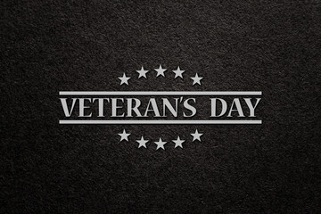 Fototapeta premium Text Veterans Day on black textured background. American holiday typography poster. Banner, flyer, sticker, greeting card, postcard.