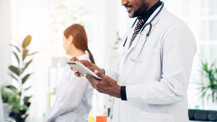 Male doctor using his digital tablet in the hospital, Concept Of Medical Technology and Healthcare...
