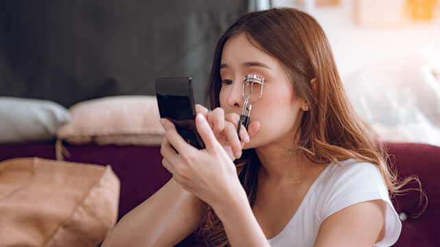 Young Asian Woman Putting Mascara Makeup In Mirror Banner Getting Ready For Work Doing Morning Makeup Routine Putting Mascara In Bathroom Mirror At Home.