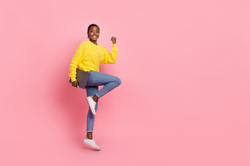 Full size profile side photo of young pretty lady jump hold laptop celebrate luck fists hand isolated over pink color background